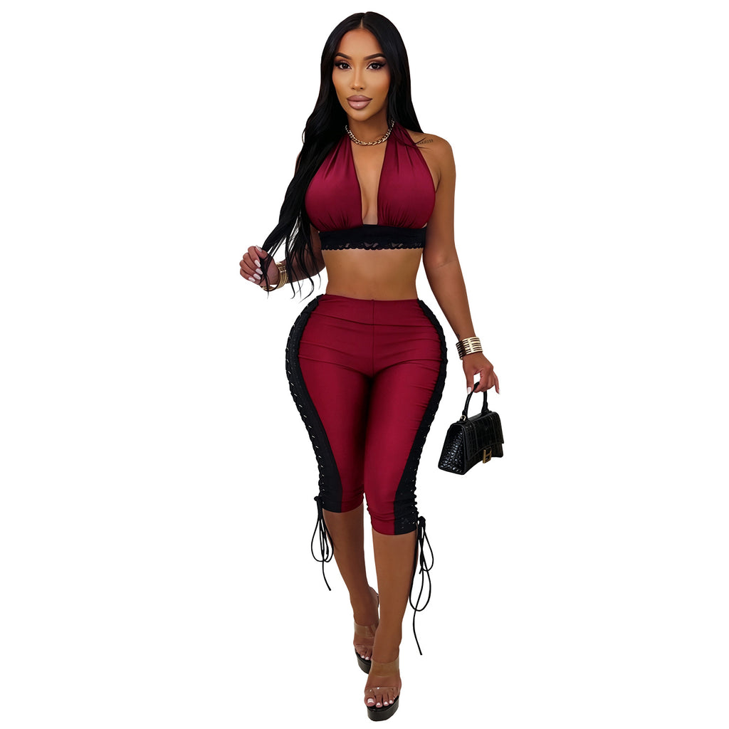 Model wearing wine-red After Hours halter crop top and matching lace-up capri pants, front view on white background