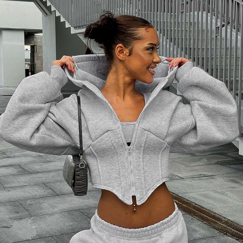 Adult model wearing the grey corset-style zip hoodie, front lifestyle view.