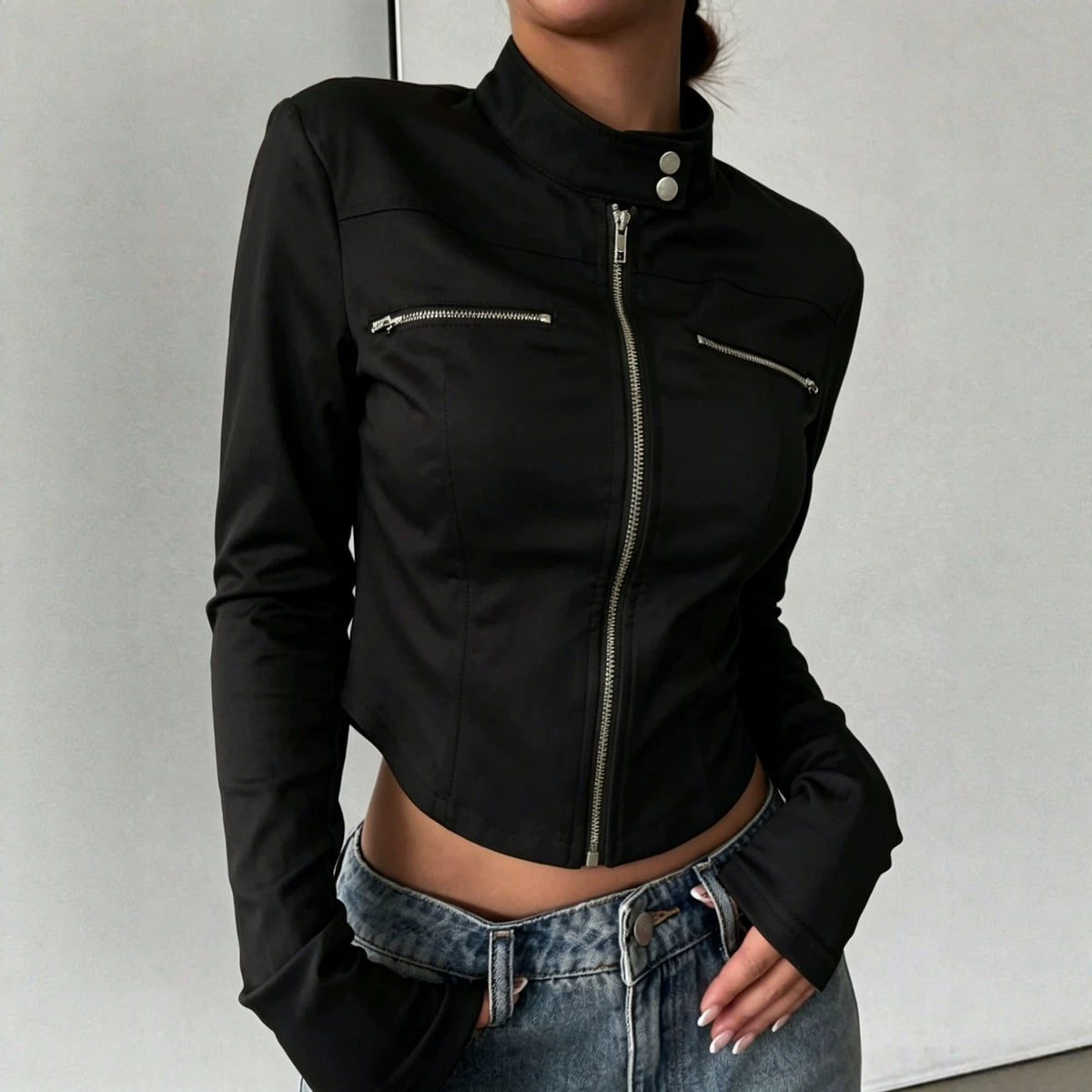 Adult model wearing the fitted black Silver Circuit Zip Jacket zipped closed with blue jeans.