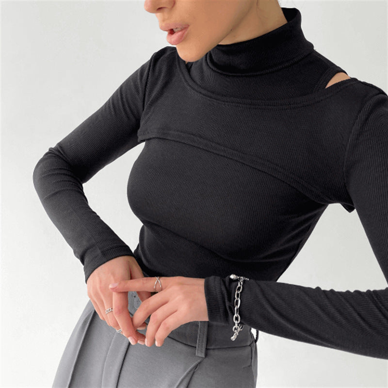 Layered Muse black mock-neck crop top shoulder detail
