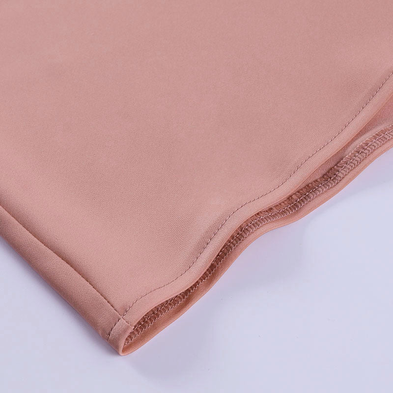 Close-up of the Champagne Hour pink satin hem stitching