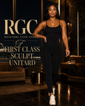First Class Sculpt Unitard in black on a confident adult model in a luxury first-class airport lounge
