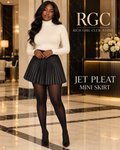 Adult model wearing the black Jet Pleat Mini Skirt with opaque tights in a luxury hotel campaign.