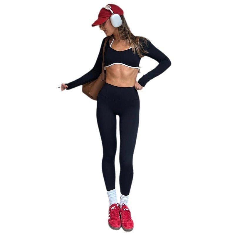 Black crop top and matching long pants, full-length adult-model cutout with red cap and headphones.