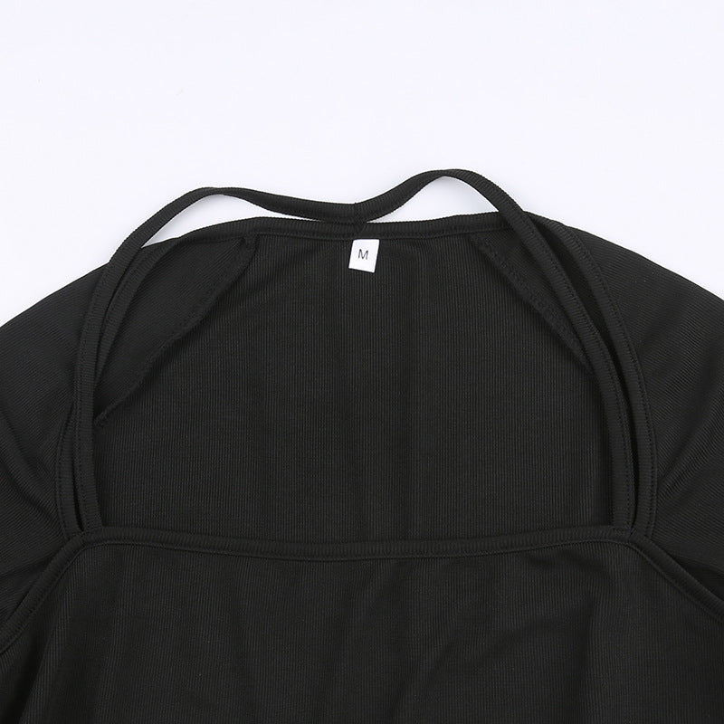 Interior neckline and size-label detail of black crop top