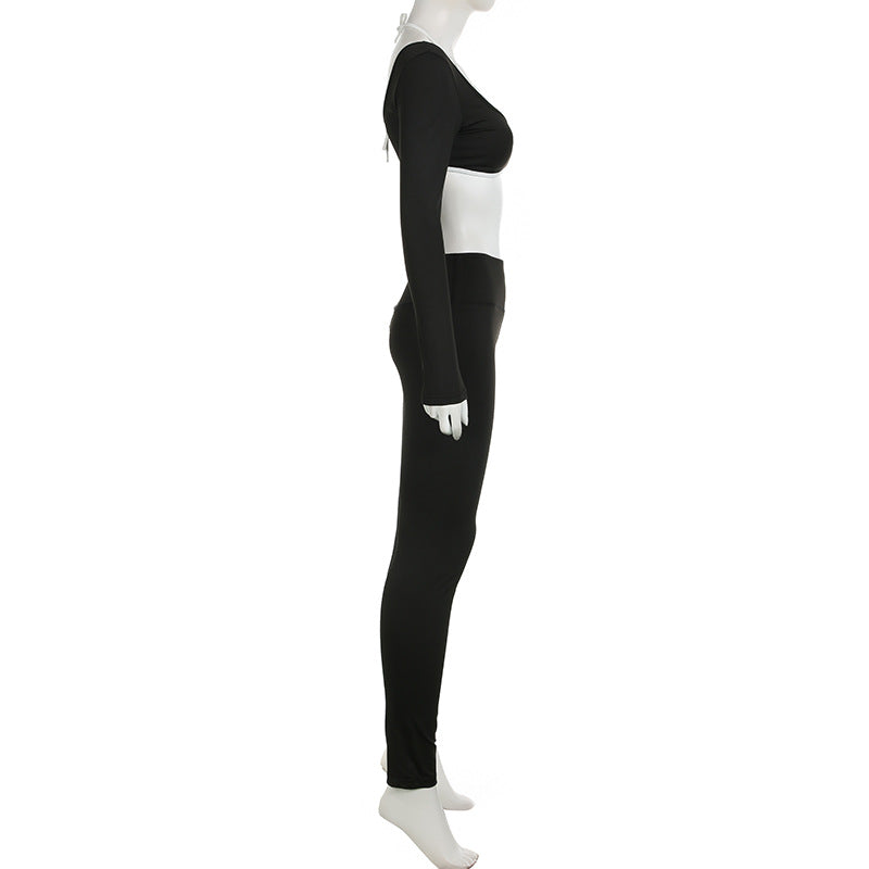 Black crop top and matching long pants on mannequin, side view