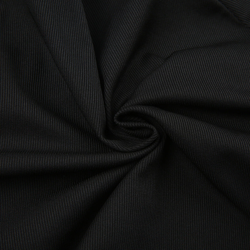Close-up of black rib-knit fabric texture gathered into folds