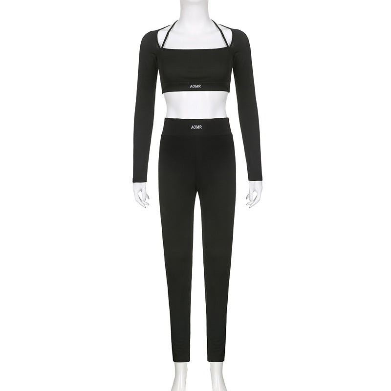 Black long-sleeve crop top and matching long pants on mannequin, full front view