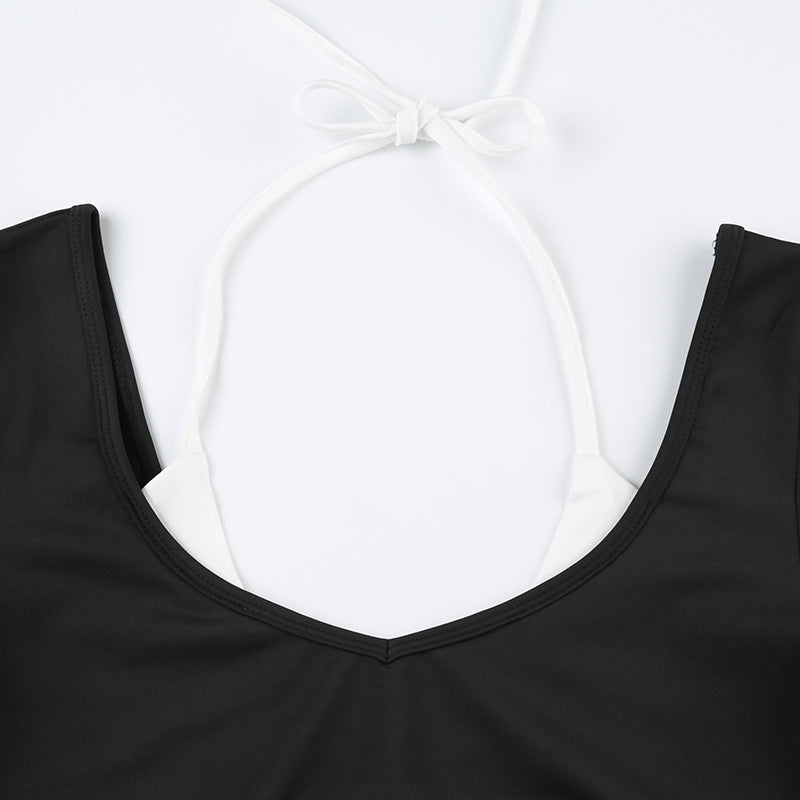 Close-up of black scoop neckline with white halter tie