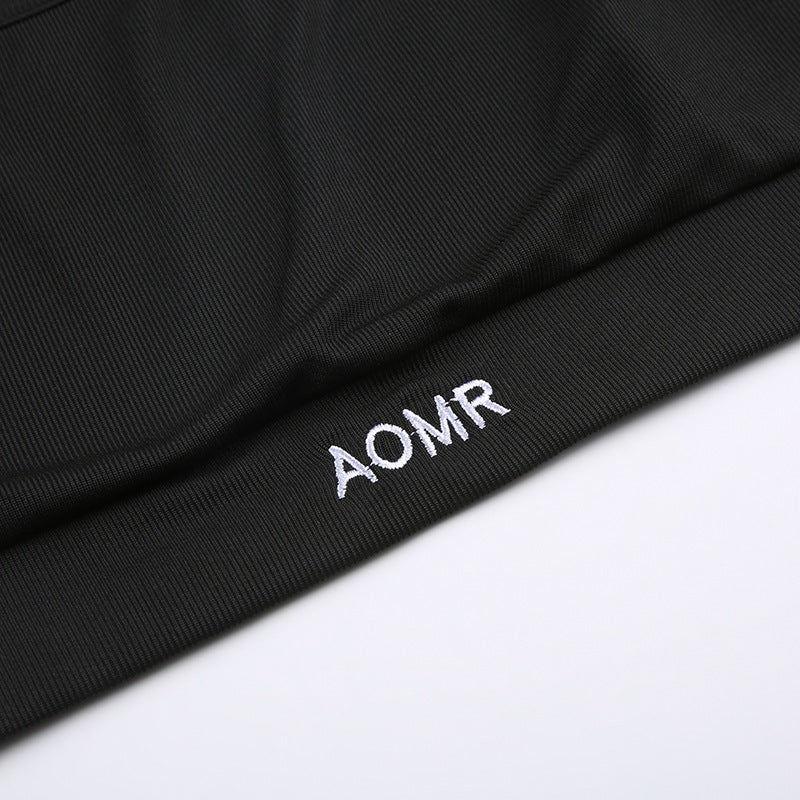 Close-up of embroidered AOMR mark on black rib-knit fabric