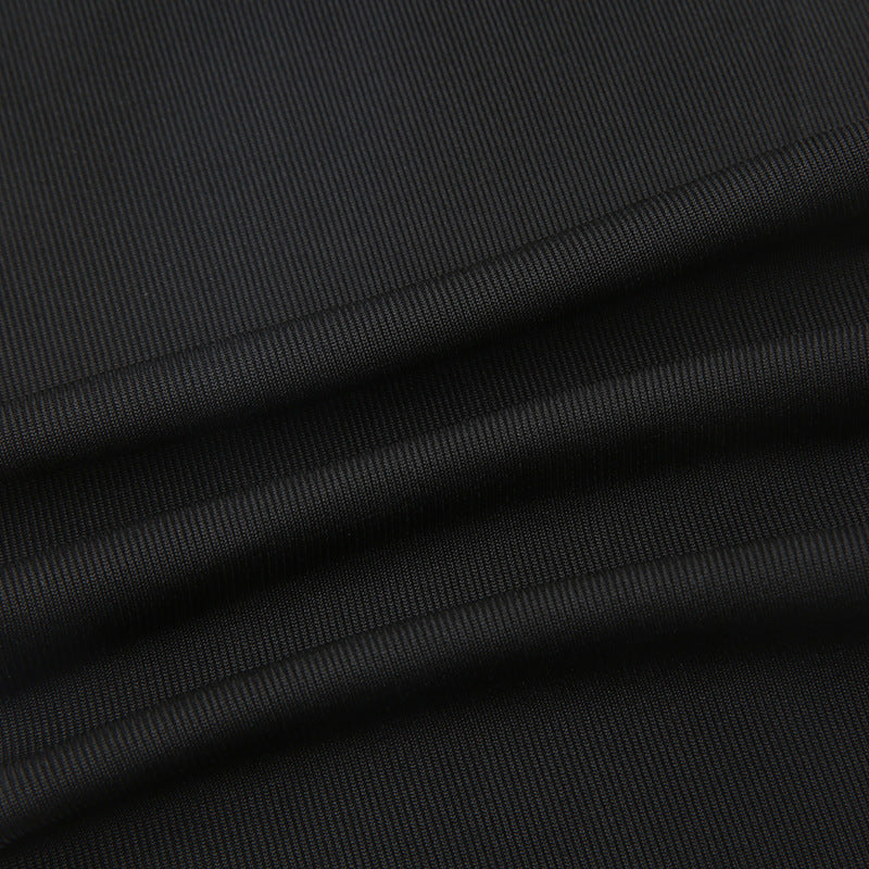 Close-up of smooth black stretch fabric texture and seam
