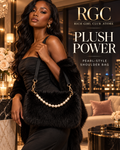 Confident adult model carrying the black Plush Power Pearl-Style Shoulder Bag in a luxury penthouse campaign.