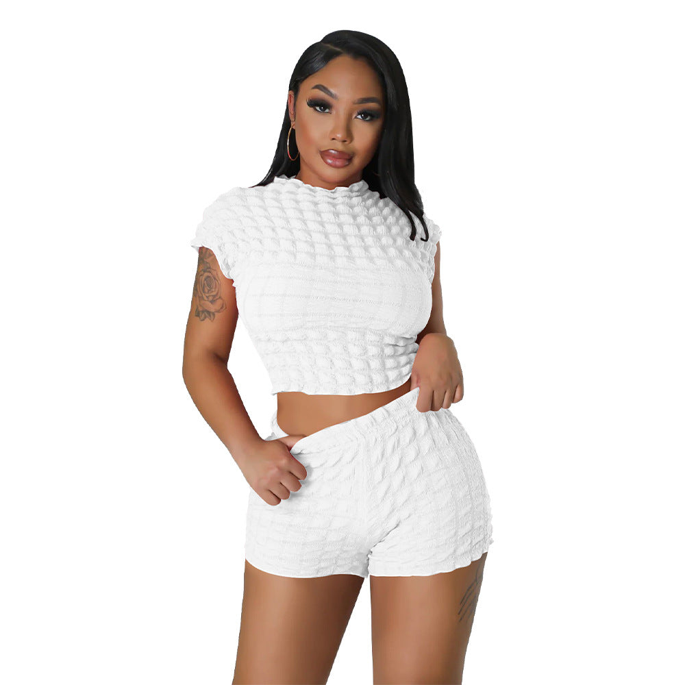 Adult model wearing the white bubble-texture crop top and matching shorts, close front view.