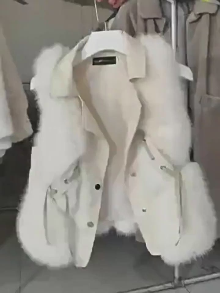 White Soft Power Faux-Fur Vest showroom video showing wide lapels, sleeveless construction, faux-fur side panels, snap front, and tied waist.