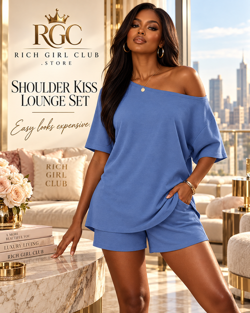 Adult model wearing the blue Shoulder Kiss Lounge Set in a luxury RGC penthouse campaign.