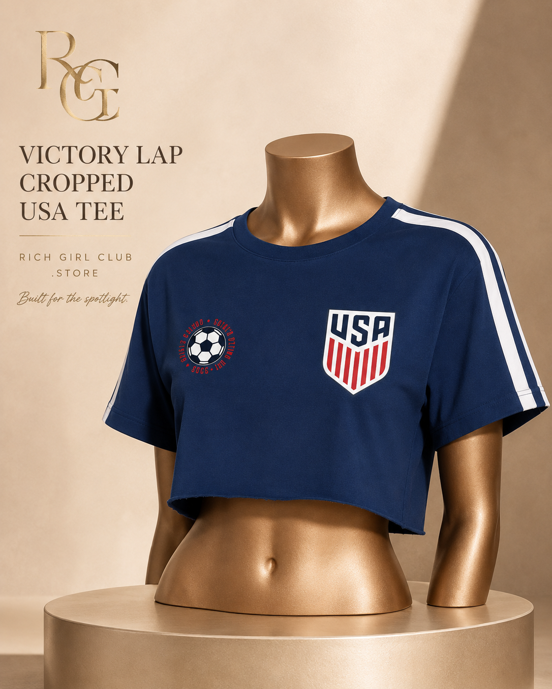 Navy Victory Lap Cropped USA Tee on a mannequin, showing the raw hem, chest graphics and white sleeve stripes