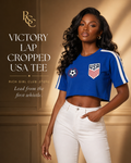 Adult model wearing the royal blue Victory Lap Cropped USA Tee in an RGC campaign, front view