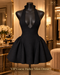 VIP Guest Halter Mini Dress in Black on a mannequin, showing the halter tie, deep-V front, fitted drop-waist bodice, gathered sides, and flared mini skirt. Styled digital visualization; not a physical-sample photograph.