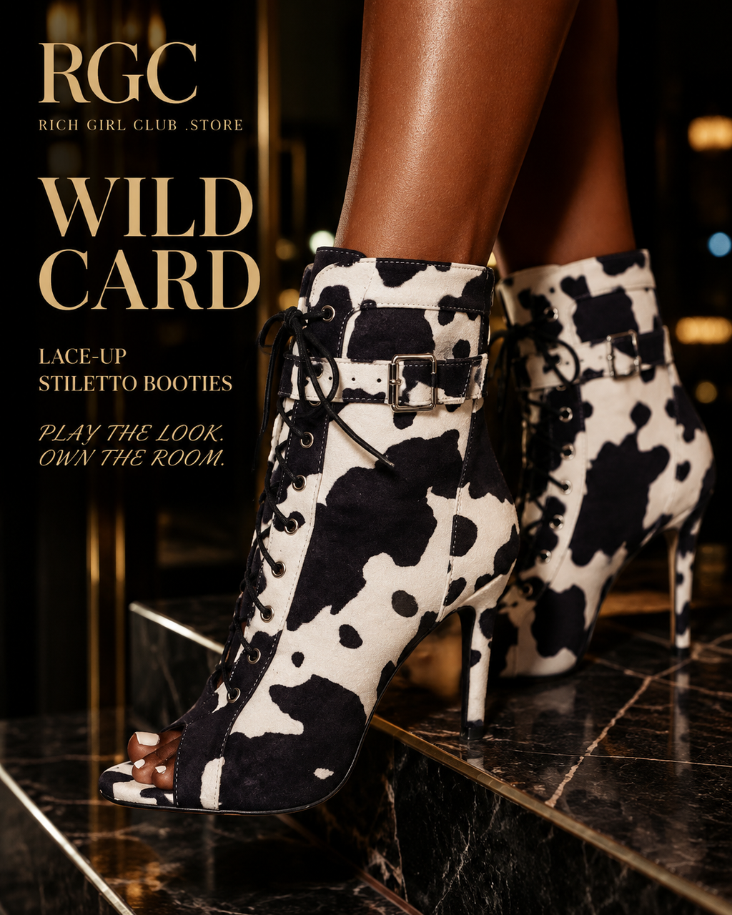 Wild Card Lace-Up Stiletto Booties RGC hero featuring black-and-white cow-print open-toe booties